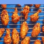 Golden brown chicken wings arranged on a wire rack over a blue background, with text above reading How Long to Bake Chicken Wings at 400°F: Simple & Delicious Chicken Wings at 400°F.