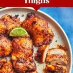 A plate of juicy baked boneless chicken thighs garnished with lime wedges. A fork holds a sliced piece. The image features text promoting a meal prep recipe using tender boneless chicken thighs.