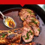 A cast iron pan holds juicy pork tenderloin in oven, sliced and garnished with herbs. A spoon rests beside the meat. Text above reads, The Best Roast Pork Tenderloin in the Oven and beatthebudget.com at the bottom.