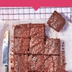 A batch of sweet potato brownies cut into squares on a wire rack with a knife beside them. Text reads: Sweet potato brownies – the ultimate hidden veg dessert. Easiest recipe at www.beatthebudget.com.