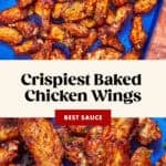 A blue tray filled with crispy baked chicken wings served with a small bowl of dipping sauce. Text on the image reads, “Crispiest Baked Chicken Wings, Best Sauce, www.beatthebudget.com.”.