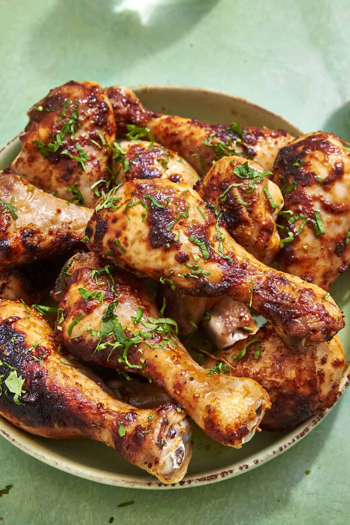 Crispy baked chicken drumsticks with hot honey butter baste on a serving plate