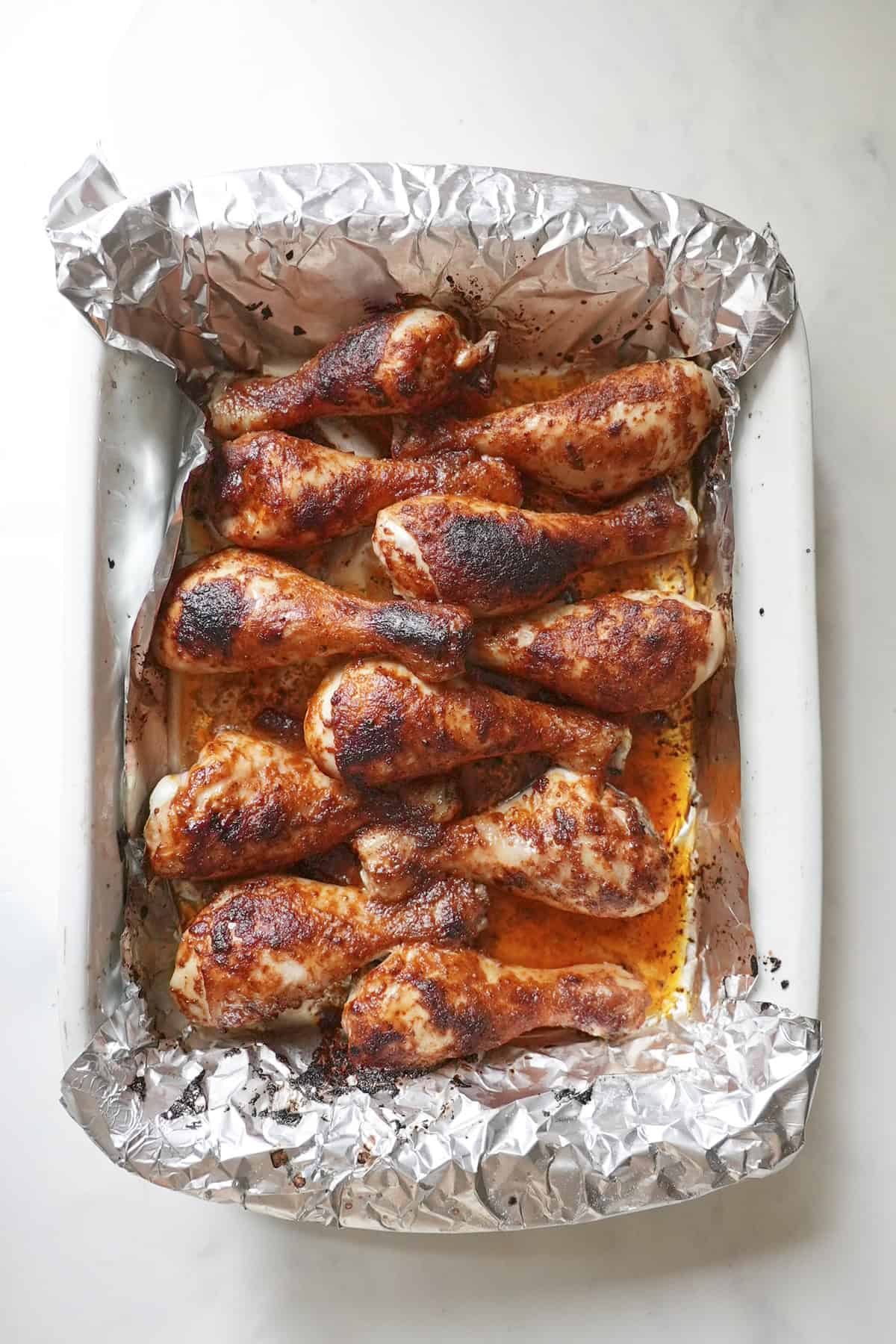 Fully baked chicken drumsticks with crispy golden skin resting before serving