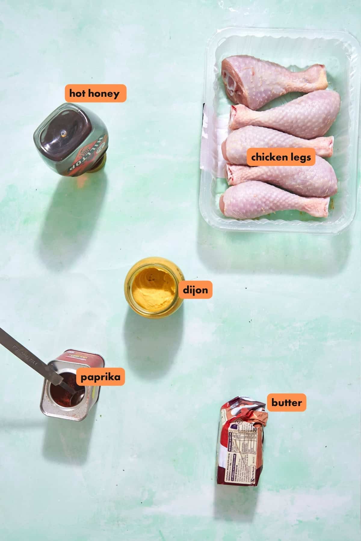 Ingredients for baked chicken drumsticks including butter, hot honey, Dijon and smoked paprika
