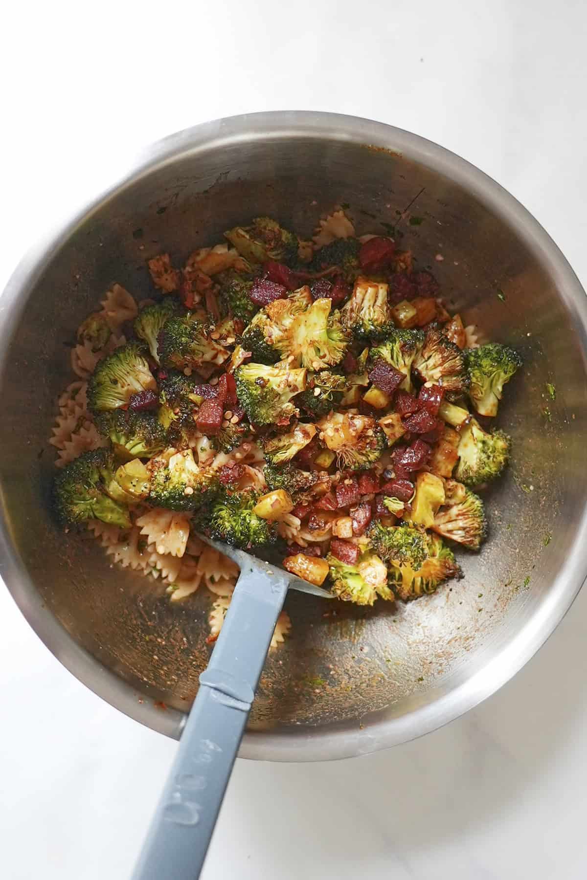 Roasted chorizo and broccoli tipped into the pasta bowl and stirred together