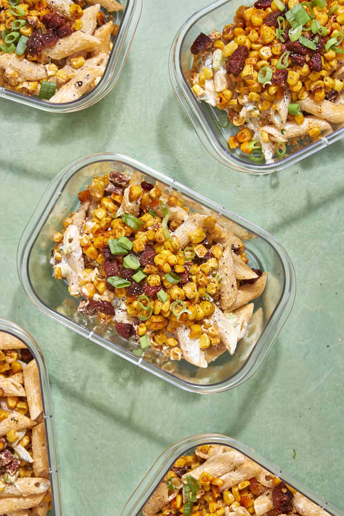 Close-up of sweetcorn pasta salad showing the creamy tzatziki coating