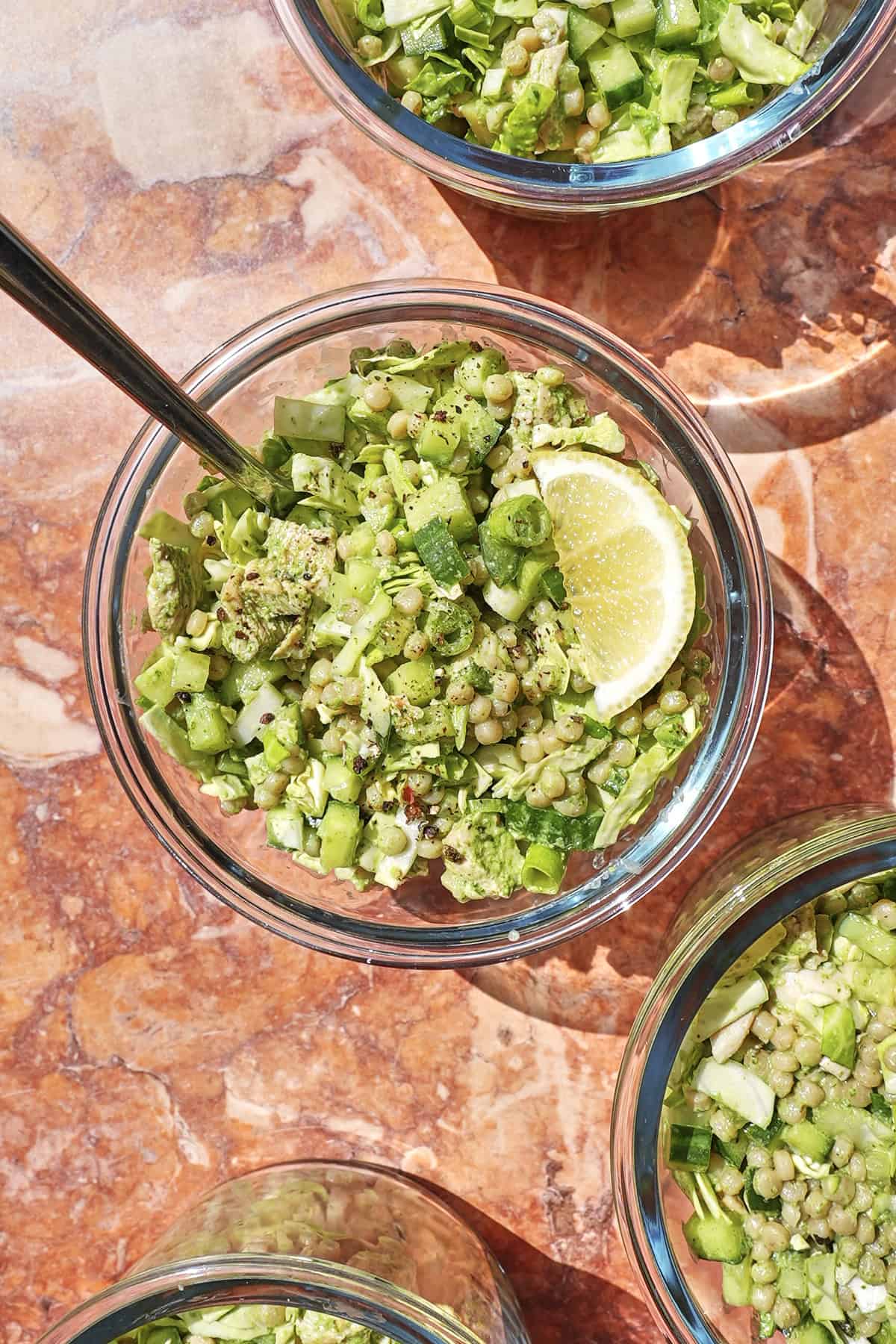Green goddess chicken salad in a meal prep container with vivid green dressing