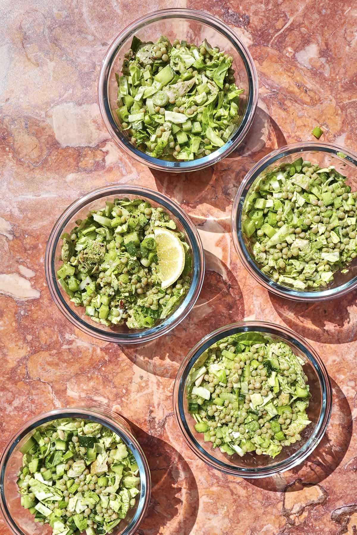 Close-up of green goddess chicken salad showing the vivid green dressing coating