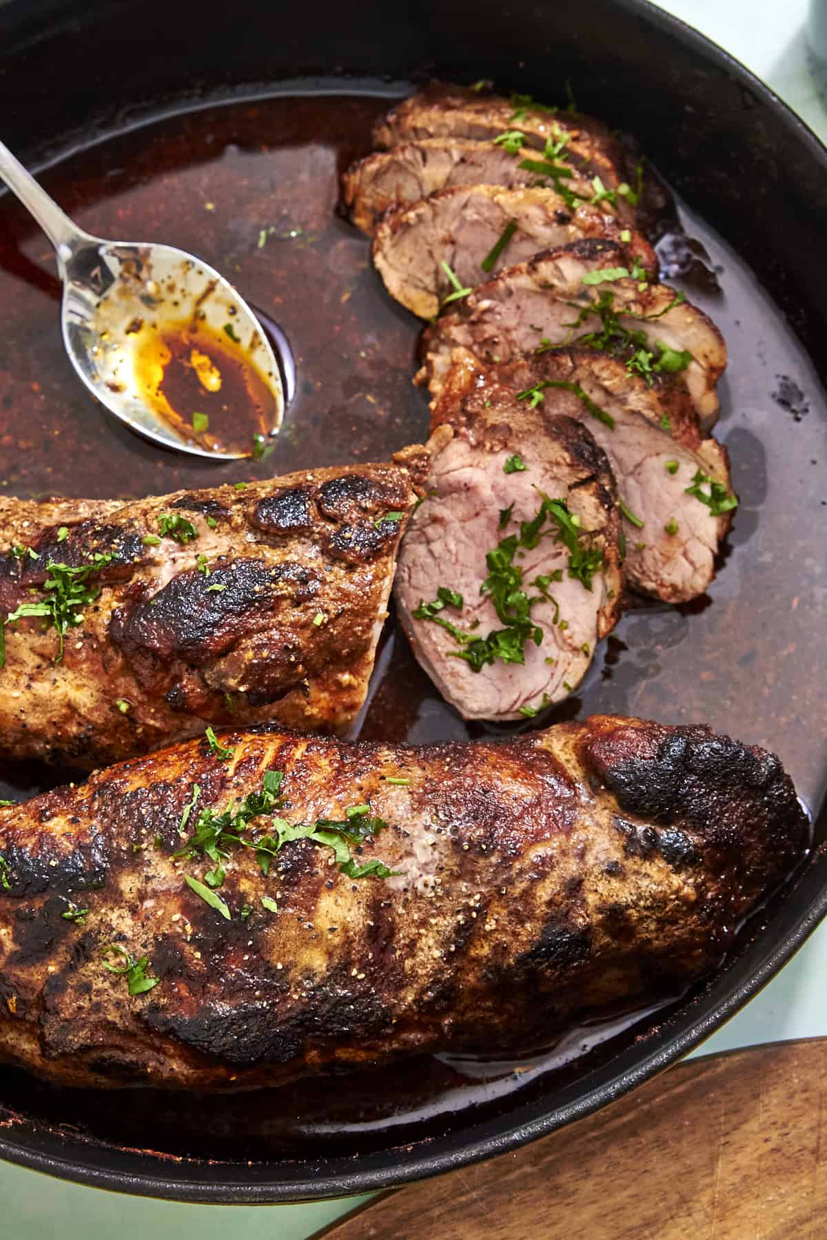 Close-up of pork tenderloin in the oven with honey Dijon compound butter glaze