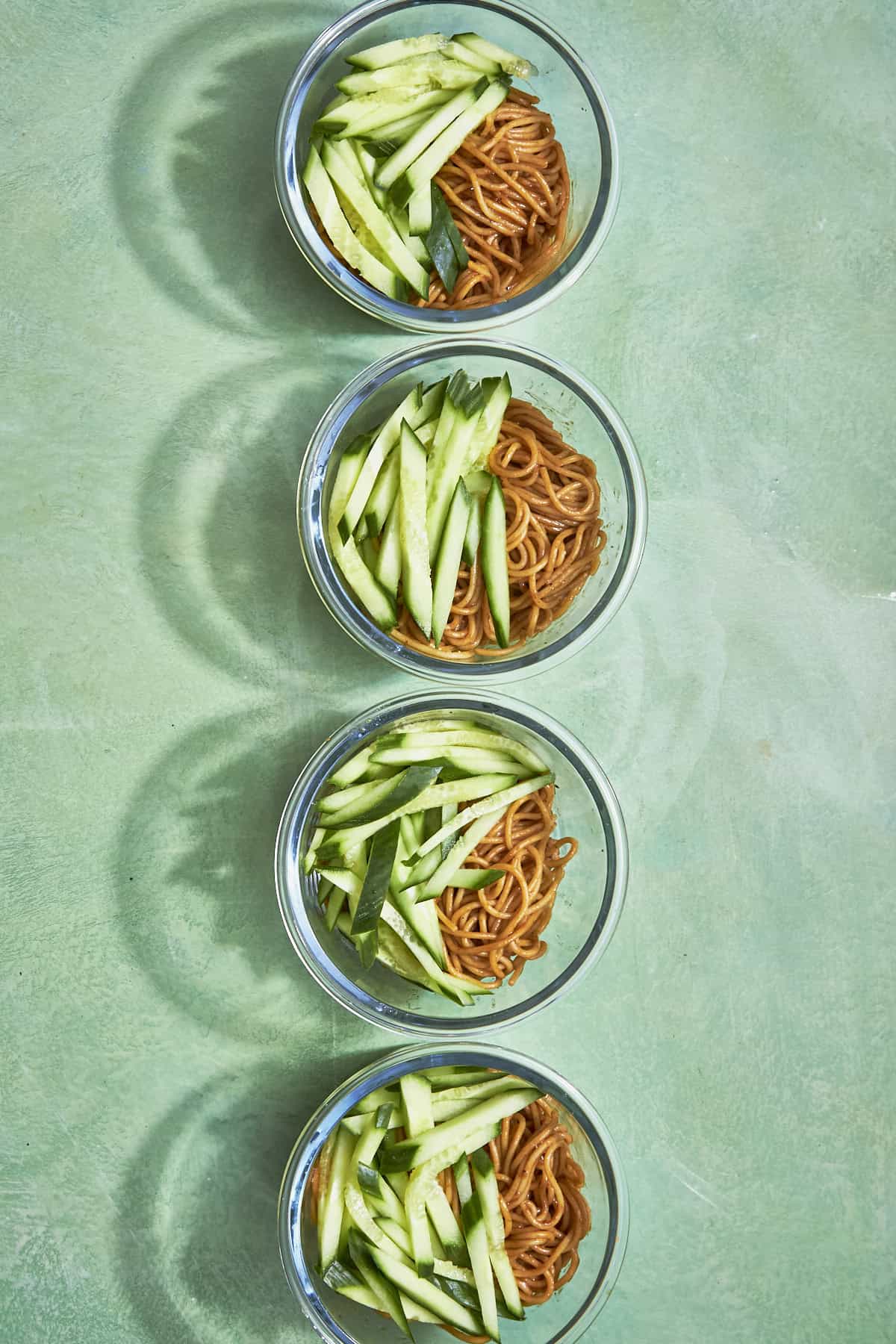 Close-up of chicken hoisin noodles with glossy hoisin sauce and curled spring onions