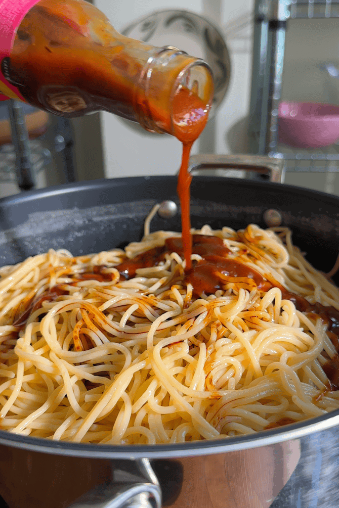 Drained spaghetti tossed in the pan with hoisin, soy sauce and rice vinegar