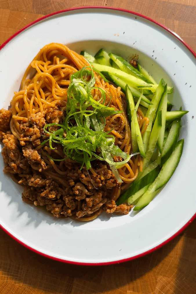 Chicken hoisin noodles and cucumber divided across 5 meal prep containers