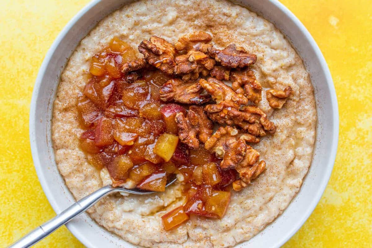 Porridge with apple sauce and walnuts in a bowl