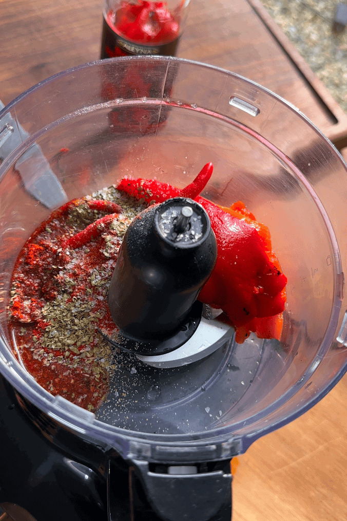 Peri peri marinade blended and rubbed over butterflied chicken breasts in a bowl
