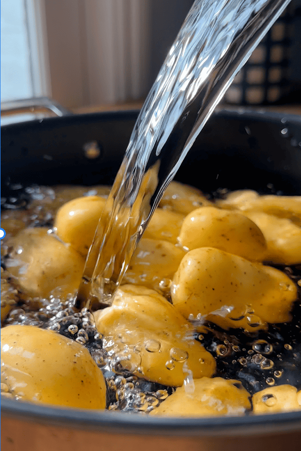 New potatoes boiling in a pan of salted water.