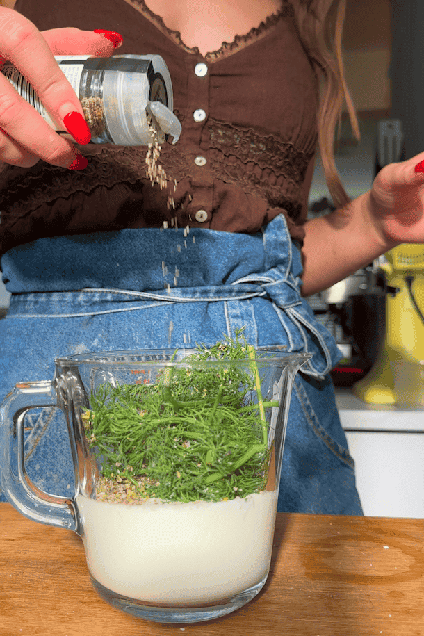 Potatoes, charred corn, bacon, celery and dill dressing combined in a large bowl.