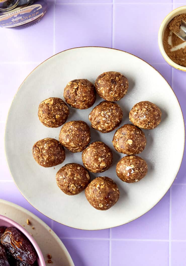 Overhead shot of energy balls with dates stacked, finished with a sprinkle of flaky sea salt.