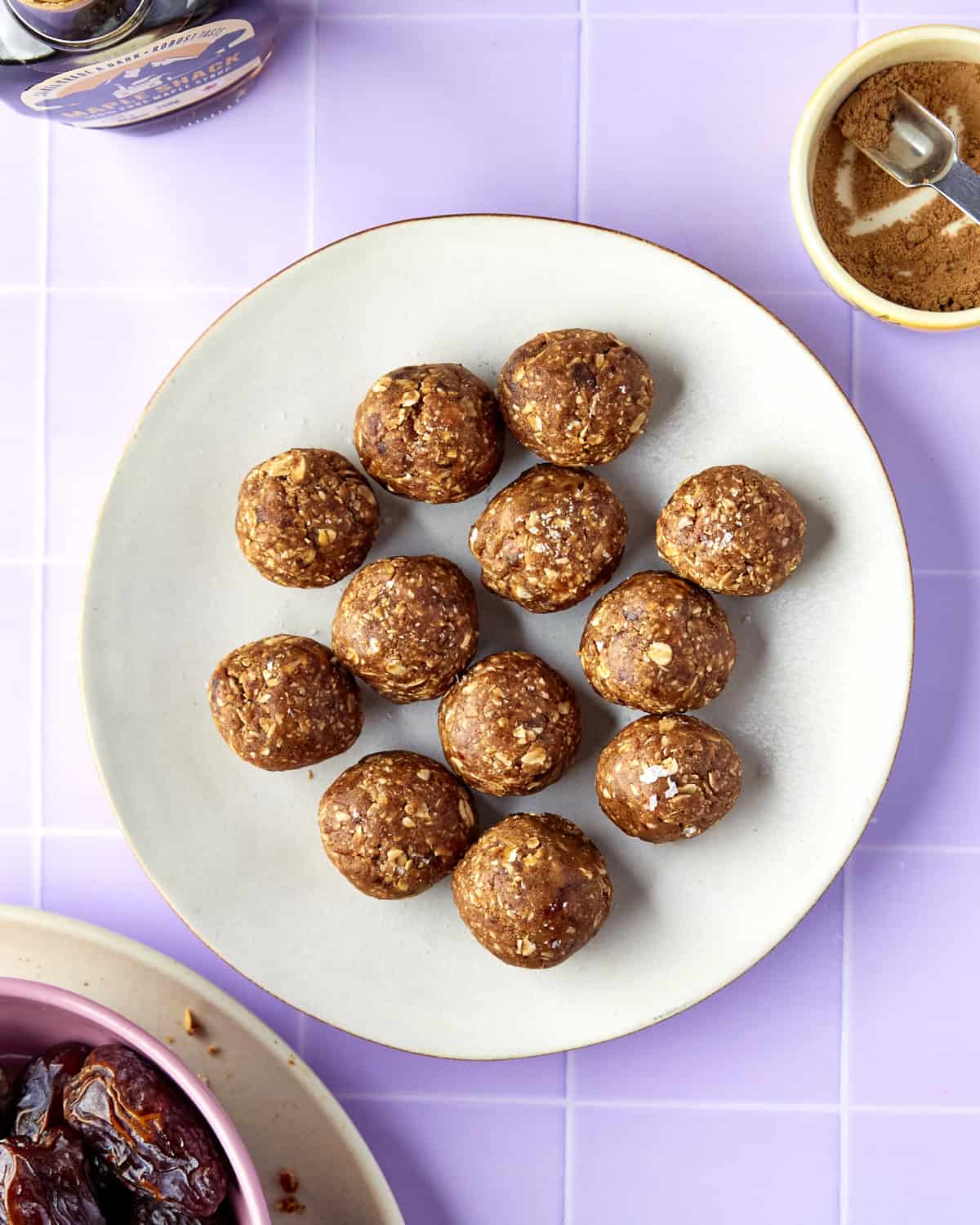 Overhead shot of energy balls with dates stacked, finished with a sprinkle of flaky sea salt.