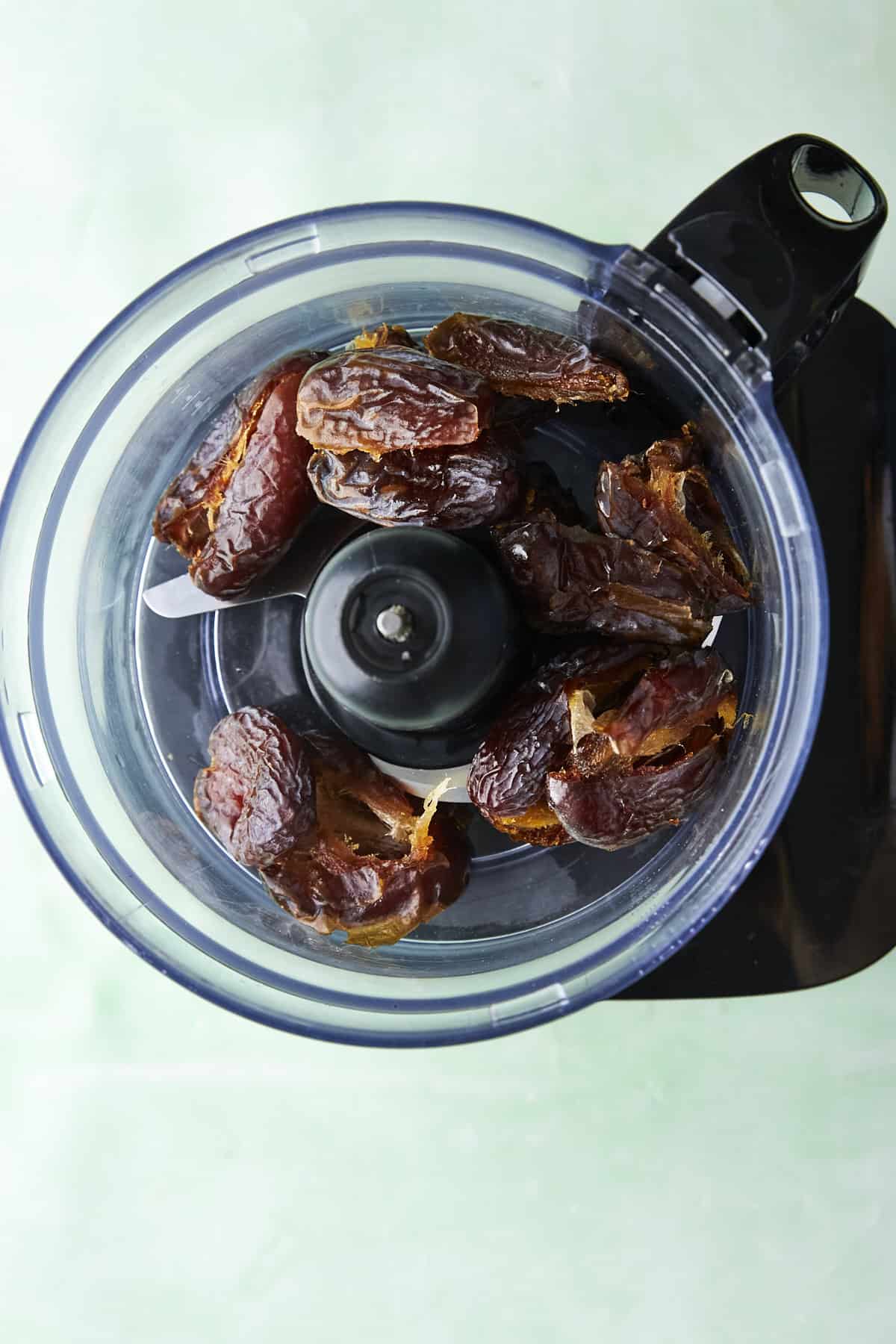 Medjool dates in a food processor, ready to be blitzed into a paste.