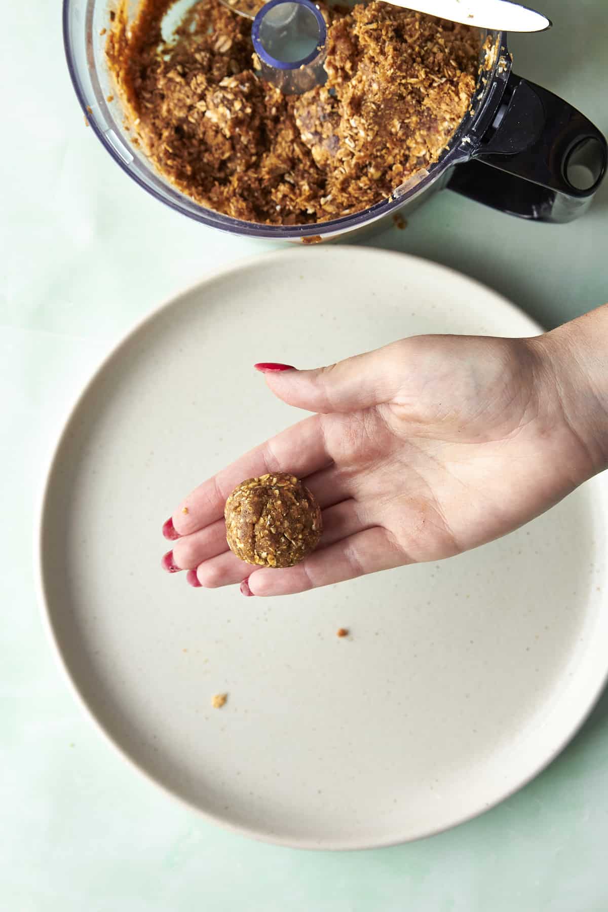 Finished energy balls with dates sprinkled with flaky sea salt.