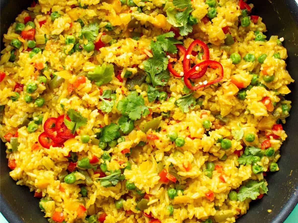 Nando's spicy rice topped with fresh cred chilli slices and coriander.