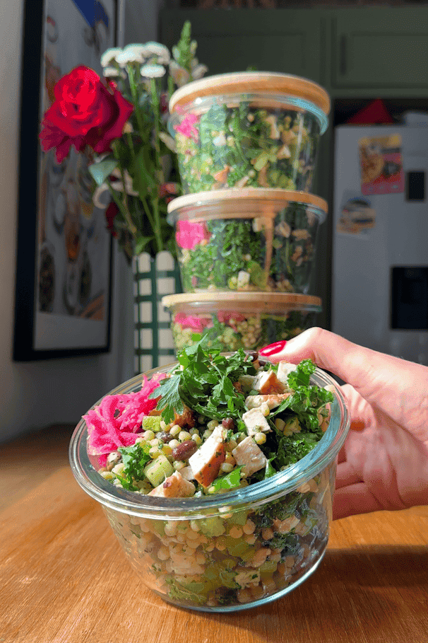 Salsa verde chopped salad packed into a glass meal prep container ready for the fridge.