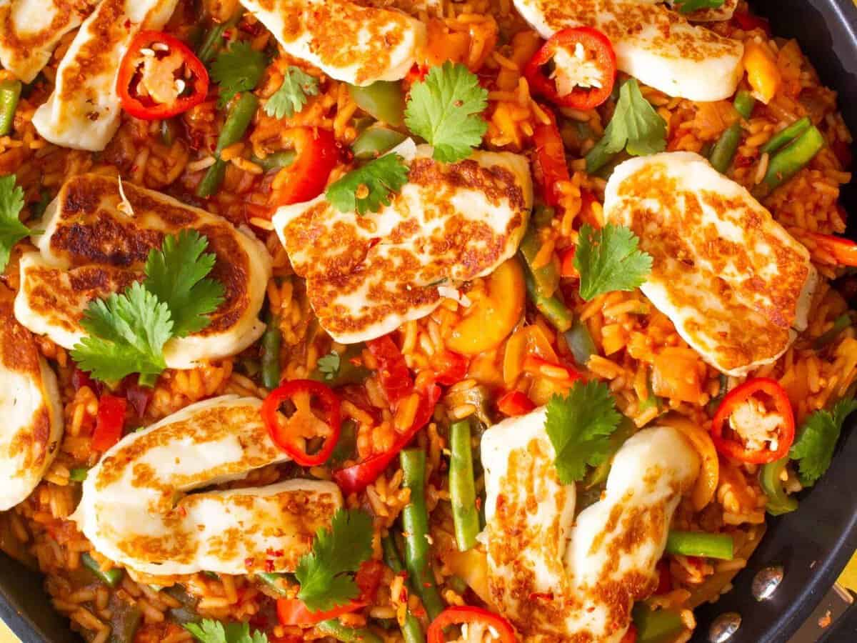 Overhead shot of tomato rice with golden browned halloumi