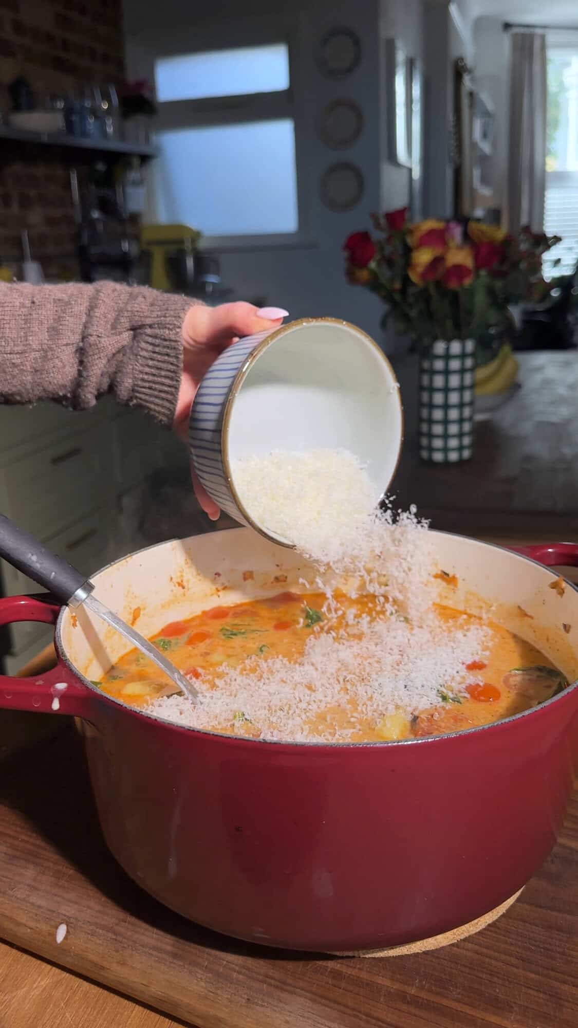 Finished creamy tuscan gnocchi soup in the pot after stirring in cream cheese and parmesan.