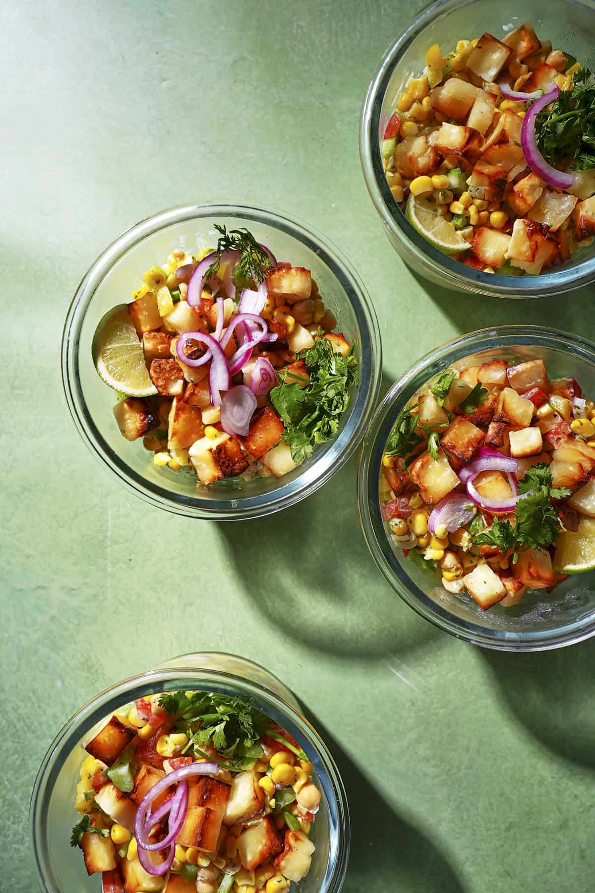 Close-up of crispy hot honey halloumi bowl with charred corn and quick-pickled onion.